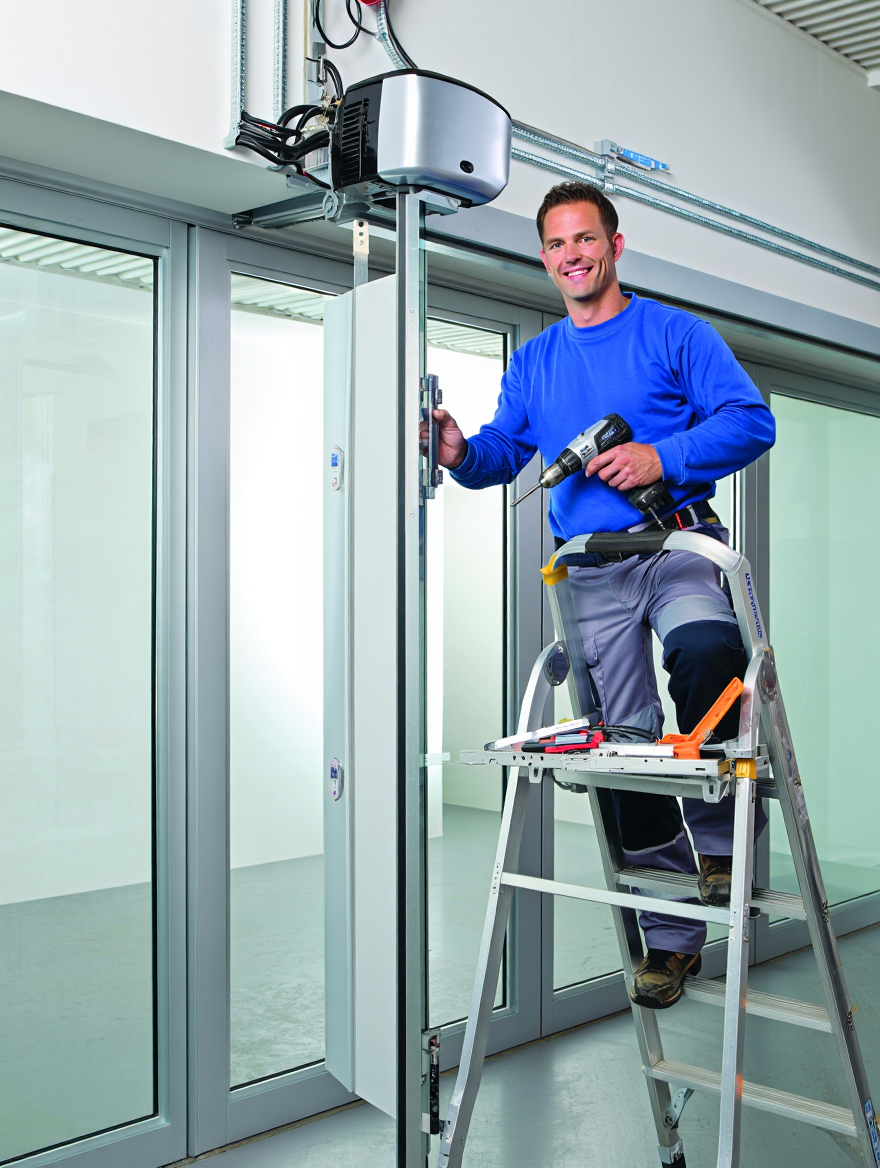 automatic door being repaired by Door Automation employee